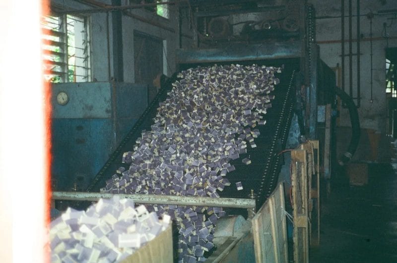 Conveyor belt transporting HDPE flakes through washing line processing stages